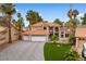 Stunning two-story home featuring a three-car garage, tiled roof, and lush landscaping, offering timeless charm at 1990 Freeman Ct, Henderson, NV 89014