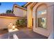 Inviting front entrance with a grand arched window, double doors, decorative lighting, and lush landscaping at 1990 Freeman Ct, Henderson, NV 89014