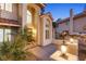 Inviting front entrance with a grand arched window, double doors, decorative lighting, and lush landscaping at 1990 Freeman Ct, Henderson, NV 89014