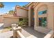 Elegant home entrance with a tiled roof, double doors, manicured landscaping, and stylish lighting at 1990 Freeman Ct, Henderson, NV 89014