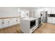 Bright kitchen featuring an island with white countertops and modern stainless steel appliances at 1990 Freeman Ct, Henderson, NV 89014
