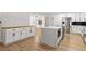 Bright kitchen featuring an island with white countertops and modern stainless steel appliances at 1990 Freeman Ct, Henderson, NV 89014