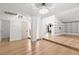 Spacious living room with hardwood floors, built-in shelving, updated lighting, and natural light from the doorway at 1990 Freeman Ct, Henderson, NV 89014