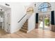 Bright living room featuring large windows, a staircase, and access to the backyard at 1990 Freeman Ct, Henderson, NV 89014