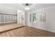 Bright living room featuring hardwood floors, a modern chandelier, and built-in shelving at 1990 Freeman Ct, Henderson, NV 89014
