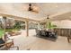 Inviting covered patio features a complete outdoor kitchen, dining area, and ceiling fans at 1990 Freeman Ct, Henderson, NV 89014