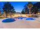 Beautiful kidney-shaped pool with decorative lighting, desert landscaping and privacy wall at 1990 Freeman Ct, Henderson, NV 89014