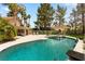 Beautiful backyard pool and patio area with lush landscaping and lounge chairs at 1990 Freeman Ct, Henderson, NV 89014
