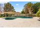 Lovely pool boasts baja step entry, dark plaster, decorative wall and desert landscaping at 1990 Freeman Ct, Henderson, NV 89014