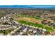 An elevated view displays golf course homes with mature landscaping situated in a vast community with city views at 2149 Eaglepath Cir, Henderson, NV 89074