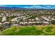 Extensive aerial view of a neighborhood nestled around a well-manicured golf course with mountain views at 2149 Eaglepath Cir, Henderson, NV 89074