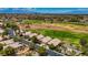 Expansive aerial view showcases a golf course community with mature landscaping and city views in the distance at 2149 Eaglepath Cir, Henderson, NV 89074