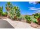 Great backyard with patio, lush landscaping, and views of the golf course at 2149 Eaglepath Cir, Henderson, NV 89074