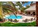Inviting community pool area with lounge chairs, cabana, and lush landscaping at 2149 Eaglepath Cir, Henderson, NV 89074