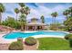 Beautiful community pool area with lounge chairs and cabana, surrounded by lush landscaping at 2149 Eaglepath Cir, Henderson, NV 89074