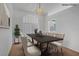 Bright dining room with chandelier, shutters, table, and chairs at 2149 Eaglepath Cir, Henderson, NV 89074