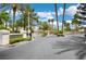 Welcoming gated community entrance with lush landscaping and mature palm trees at 2149 Eaglepath Cir, Henderson, NV 89074