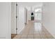 Bright hallway featuring neutral tile flooring, an arched fireplace, and an open view of the house at 2149 Eaglepath Cir, Henderson, NV 89074