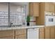 Well-lit kitchen featuring tile countertops, stainless steel appliances and light wood cabinetry at 2149 Eaglepath Cir, Henderson, NV 89074