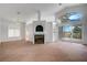 Spacious living room with large windows showcasing the backyard, fireplace, and golf course views at 2149 Eaglepath Cir, Henderson, NV 89074