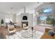 Bright living room with fireplace and golf course views, staged with modern furnishings at 2149 Eaglepath Cir, Henderson, NV 89074