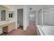 The main bathroom with a separate shower and garden tub and a view into the main bedroom at 2149 Eaglepath Cir, Henderson, NV 89074