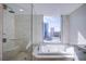 Modern bathroom features a soaking tub and separate shower with a bench at 222 Karen Ave # 2308, Las Vegas, NV 89109