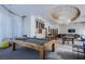 Resident game room with a wooden pool table, comfortable seating, and contemporary lighting at 222 Karen Ave # 2308, Las Vegas, NV 89109
