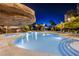 Community pool illuminated at night featuring cool rock features and condos in the background at 222 Karen Ave # 2308, Las Vegas, NV 89109