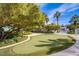 Community putting green surrounded by lush landscaping, mature trees, and walking paths at 222 Karen Ave # 2308, Las Vegas, NV 89109
