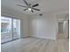 Bright, freshly painted living room featuring modern ceiling fan and sliding glass doors to the balcony at 2251 Wigwam Pkwy # 716, Henderson, NV 89074