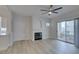 Bright living room featuring a stylish fireplace, sleek grey floors, and a sliding glass door to the balcony at 2251 Wigwam Pkwy # 716, Henderson, NV 89074