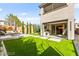The artificial turf backyard has a covered patio with a built-in kitchen at 2407 Ridgeline Wash St, Las Vegas, NV 89138