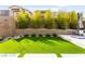 Artificial turf backyard with stone walkway and lush landscaping at 2407 Ridgeline Wash St, Las Vegas, NV 89138