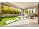 An outdoor kitchen features a built-in grill in this spacious backyard at 2407 Ridgeline Wash St, Las Vegas, NV 89138