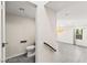Bright bathroom featuring a toilet next to a modern living space with natural light and tile floors at 2407 Ridgeline Wash St, Las Vegas, NV 89138