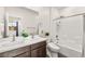 Bathroom featuring double sinks, white cabinets, and a shower-tub combo with tile surround at 2407 Ridgeline Wash St, Las Vegas, NV 89138