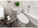 Close-up of toilet featuring modern bidet functions with a white tile tub in the background at 2407 Ridgeline Wash St, Las Vegas, NV 89138