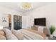 Virtually staged bedroom features stylish decor, shelving, and a mounted television at 2407 Ridgeline Wash St, Las Vegas, NV 89138