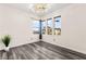 Neutral bedroom features stylish gray wood floors, multiple windows, and a unique light fixture at 2407 Ridgeline Wash St, Las Vegas, NV 89138