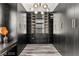 Spacious walk-in closet with custom shelving, drawers and unique lighting fixture at 2407 Ridgeline Wash St, Las Vegas, NV 89138