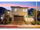 A modern two-story home with a brick driveway, a two-car garage, and desert landscaping at 2407 Ridgeline Wash St, Las Vegas, NV 89138