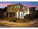 A modern two-story home boasts desert landscaping, a two-car garage, and a welcoming blue front door at 2407 Ridgeline Wash St, Las Vegas, NV 89138