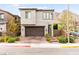 Contemporary two-story home with a brick driveway, attached garage, and desert landscaping at 2407 Ridgeline Wash St, Las Vegas, NV 89138