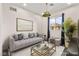Staged living room featuring stylish gray sofa, modern coffee table, and view of the mountains at 2407 Ridgeline Wash St, Las Vegas, NV 89138