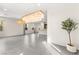 Open-concept living space with tile flooring, modern chandeliers, and abundant natural light at 2407 Ridgeline Wash St, Las Vegas, NV 89138