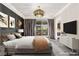 Inviting main bedroom featuring neutral tones, a large bed, balcony access, and a wall-mounted television at 2407 Ridgeline Wash St, Las Vegas, NV 89138