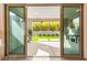 View of the covered patio and backyard through open sliding glass doors at 2407 Ridgeline Wash St, Las Vegas, NV 89138