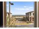 Exterior view from window showcasing desert landscaping, neighboring homes, and a clear blue sky at 2407 Ridgeline Wash St, Las Vegas, NV 89138