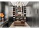 Organized walk-in closet with shelving, drawers, seating, and ample space for shoes and handbags at 2407 Ridgeline Wash St, Las Vegas, NV 89138